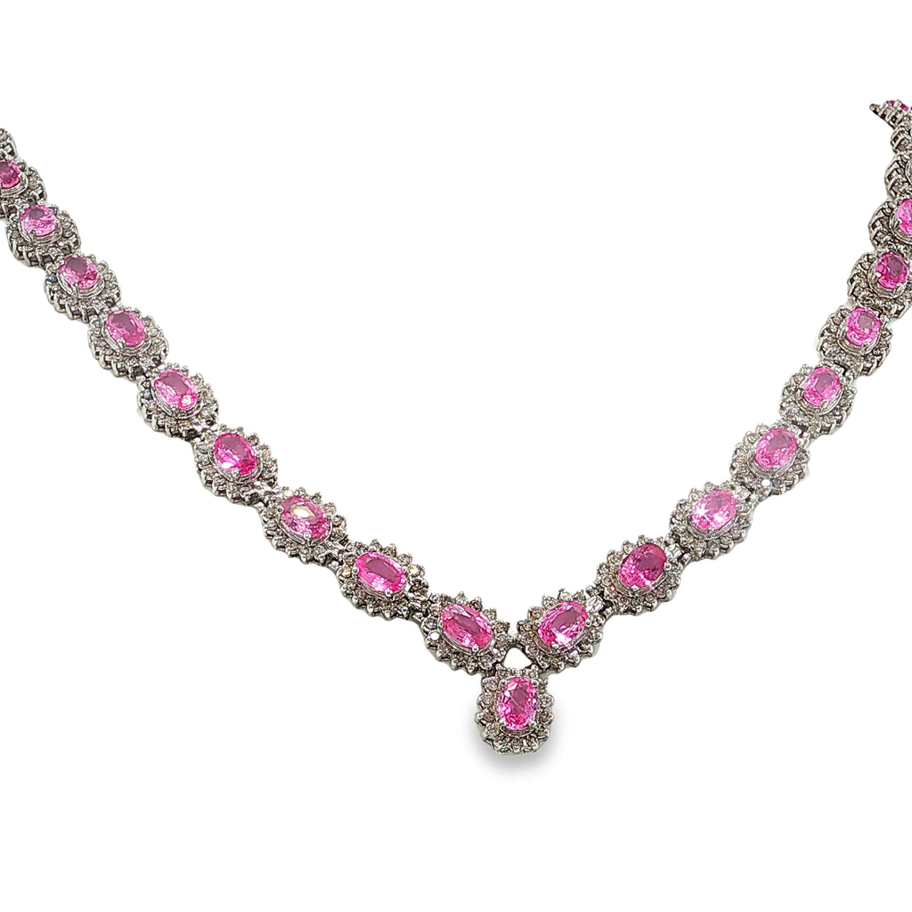 14K white gold pink sapphire and diamond necklace with oval pink sapphires, diamond halos, and a graduated center drop.