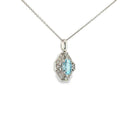 Oval aquamarine and diamond geometric pendant necklace in 14K white gold.