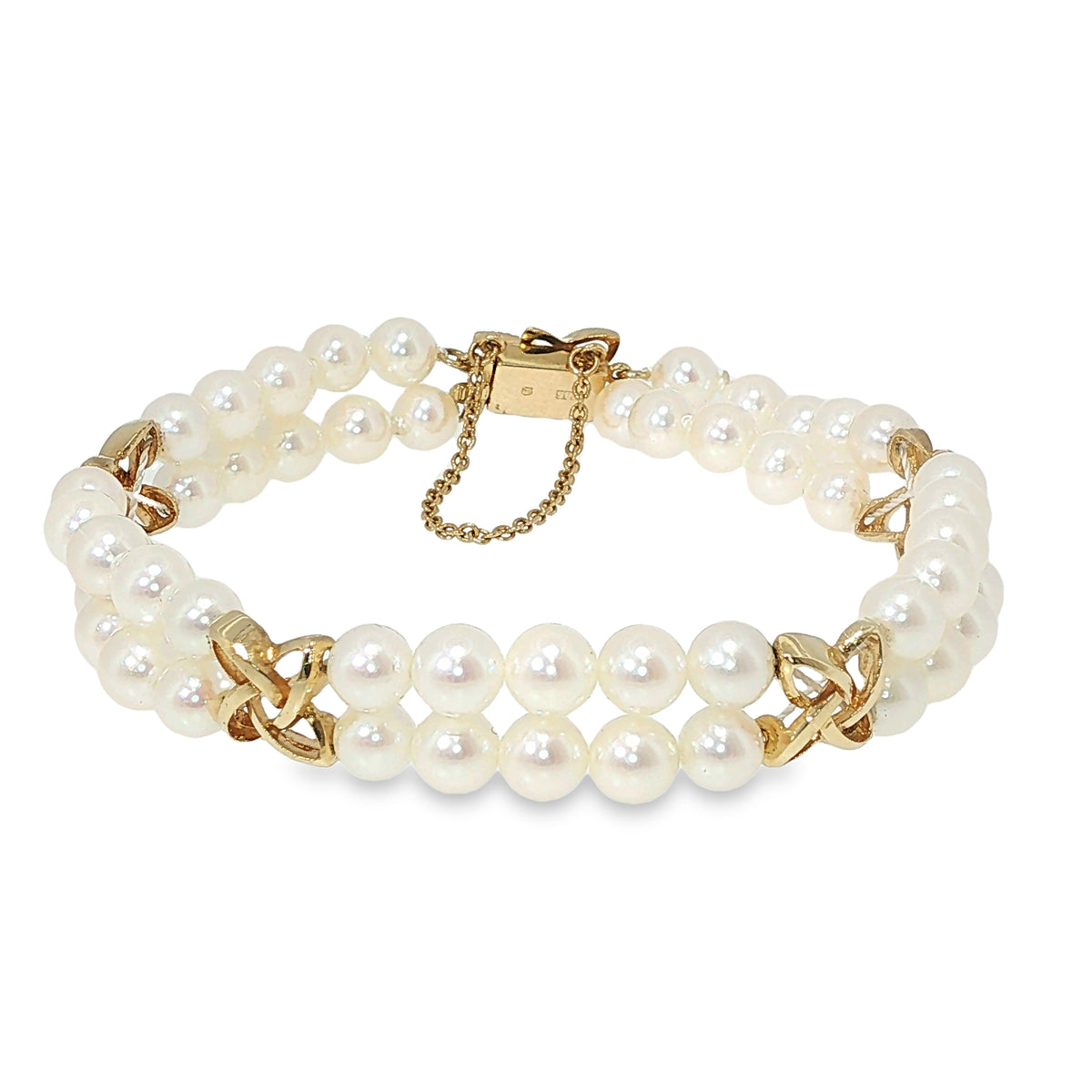 Mikimoto double-strand Akoya pearl bracelet with yellow gold star-style stations and 5.5–6 MM pearls.