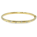 Tiffany & Co. 18K yellow gold and platinum bangle bracelet with scattered flush-set diamonds.