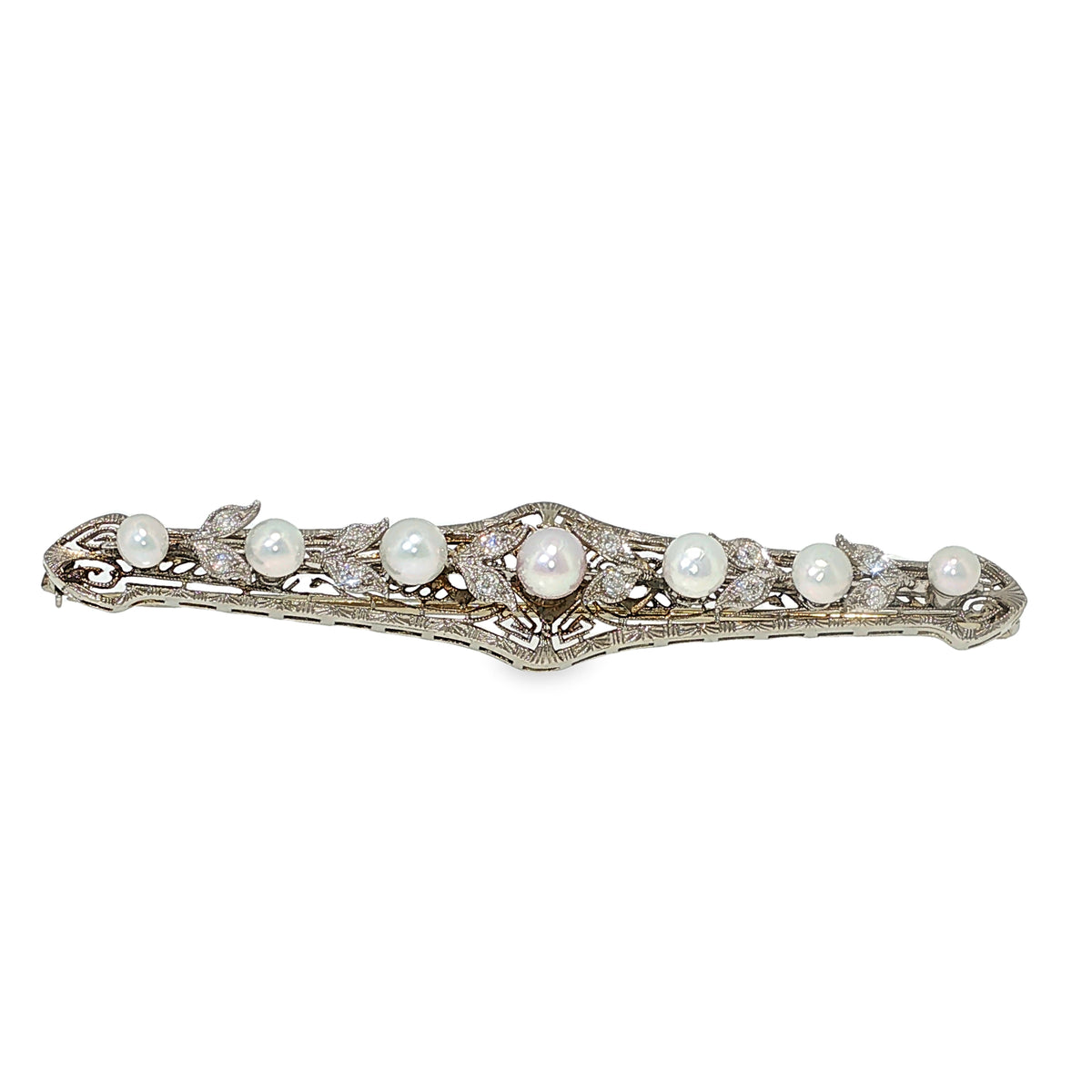 Vintage 18K white gold filigree bar brooch with freshwater button pearls and old European-cut diamond accents.