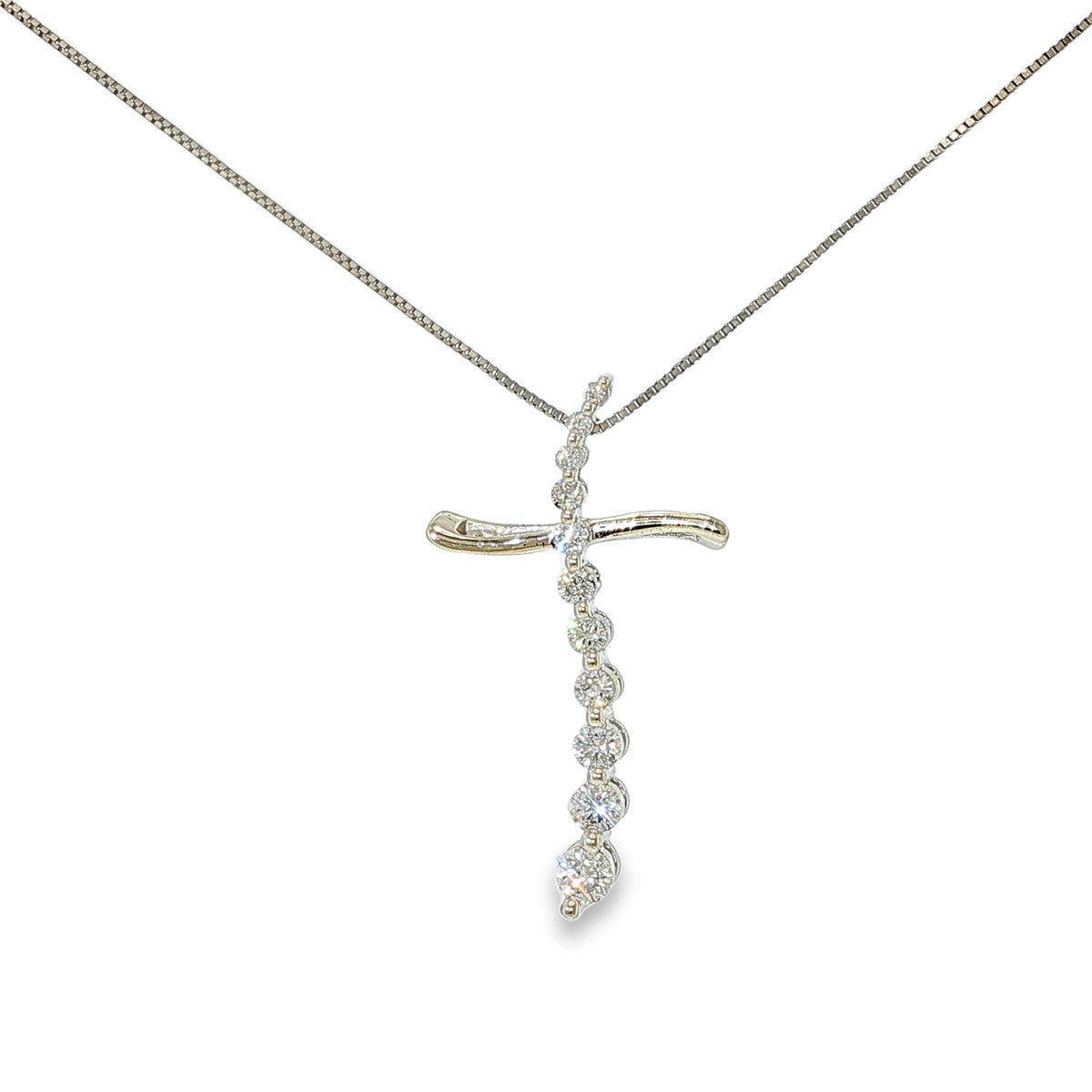 14K white gold journey cross necklace with 11 round brilliant diamonds and an 18-inch box chain.