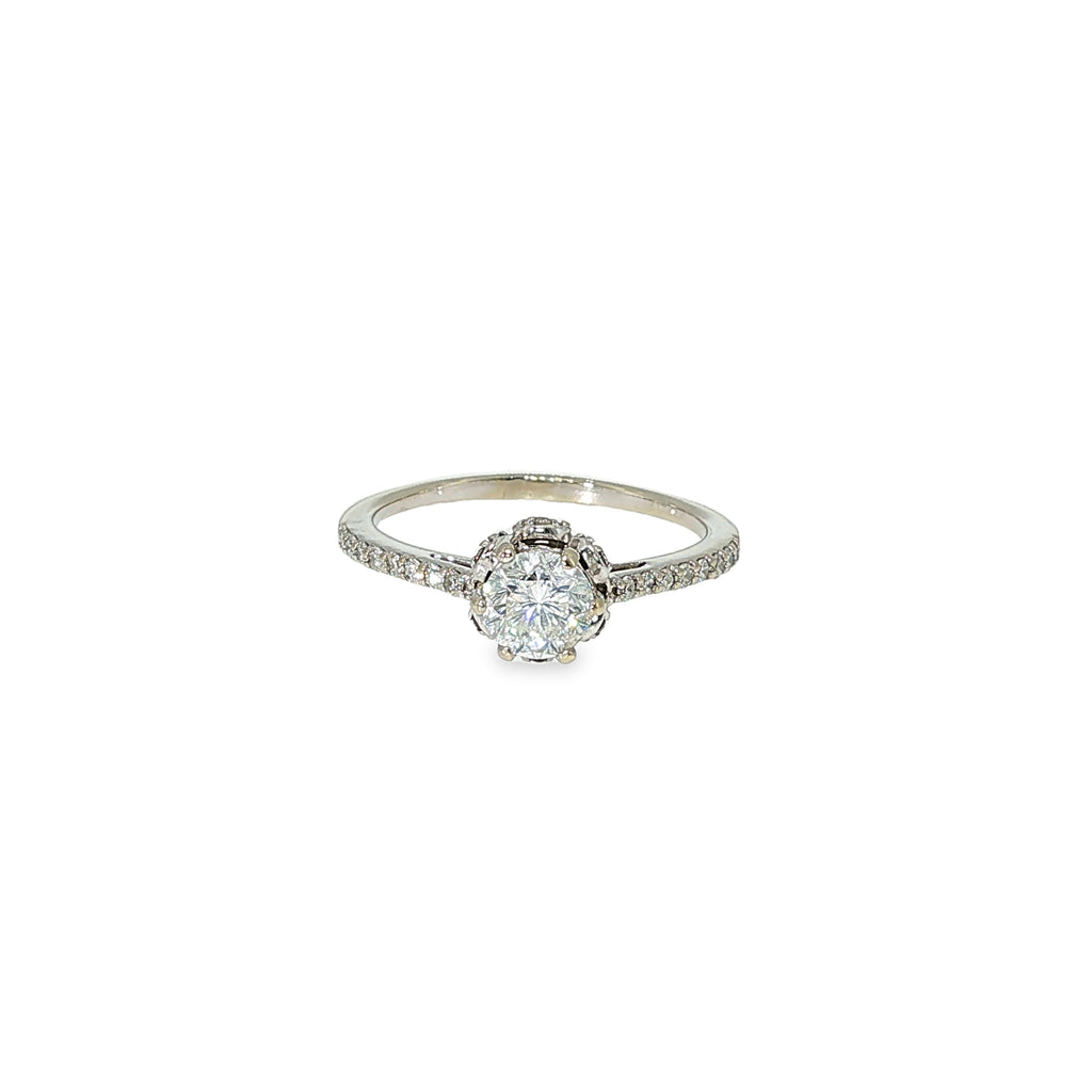 Round brilliant diamond engagement ring with a hidden halo and diamond-accented band in 14K white gold.