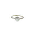 Round brilliant diamond engagement ring with a hidden halo and diamond-accented band in 14K white gold.