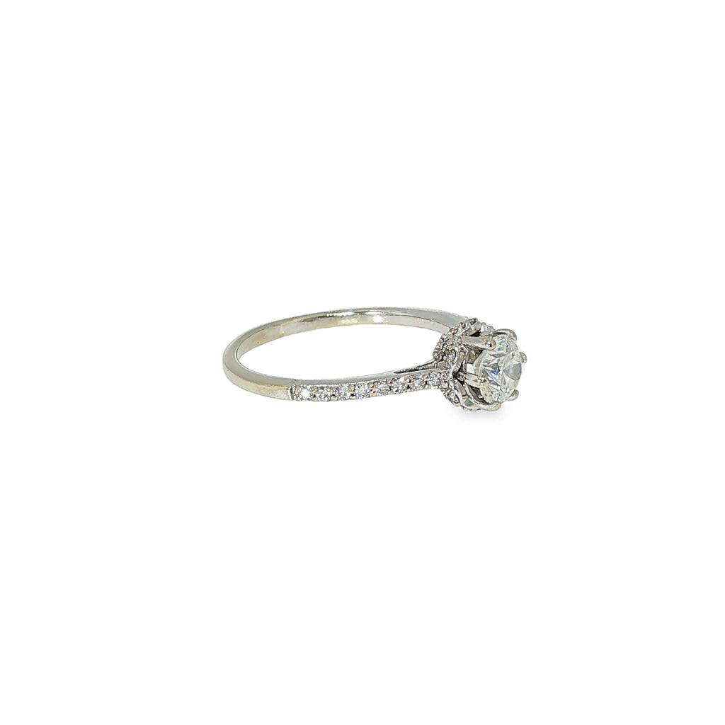 Round brilliant diamond engagement ring with a hidden halo and diamond-accented band in 14K white gold.