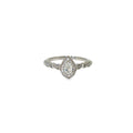 Pear-shaped diamond halo engagement ring in 14K white gold with round diamond accents along the band.