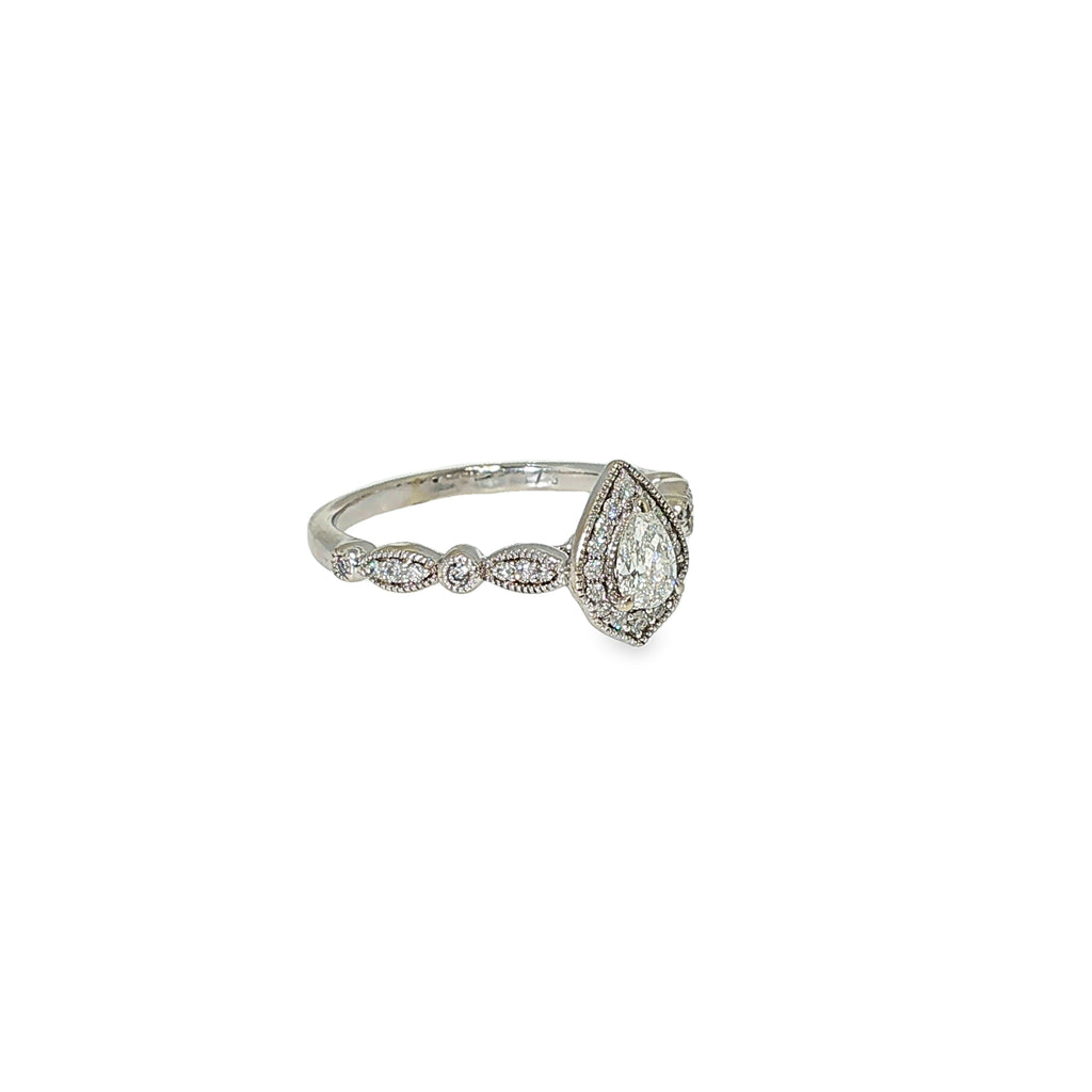Pear-shaped diamond halo engagement ring in 14K white gold with round diamond accents along the band.