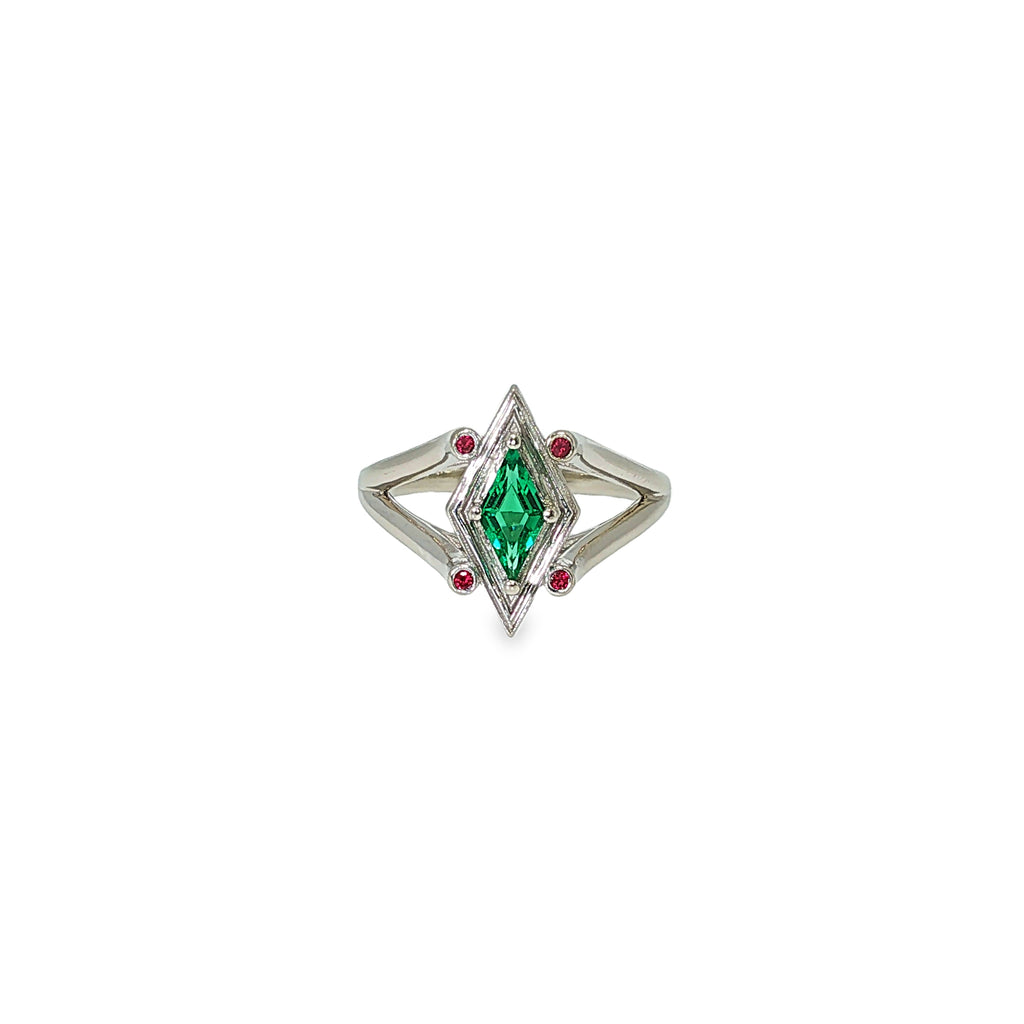 14K white gold geometric ring with a diamond-shaped lab-grown emerald and four small ruby accents.