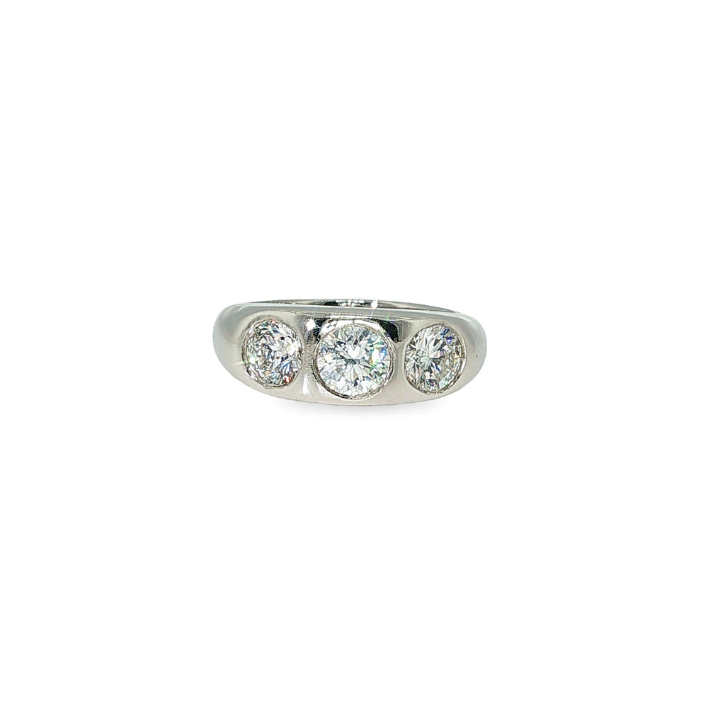 Platinum band with three round brilliant diamonds flush set across the center.