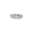 Platinum band with three round brilliant diamonds flush set across the center.