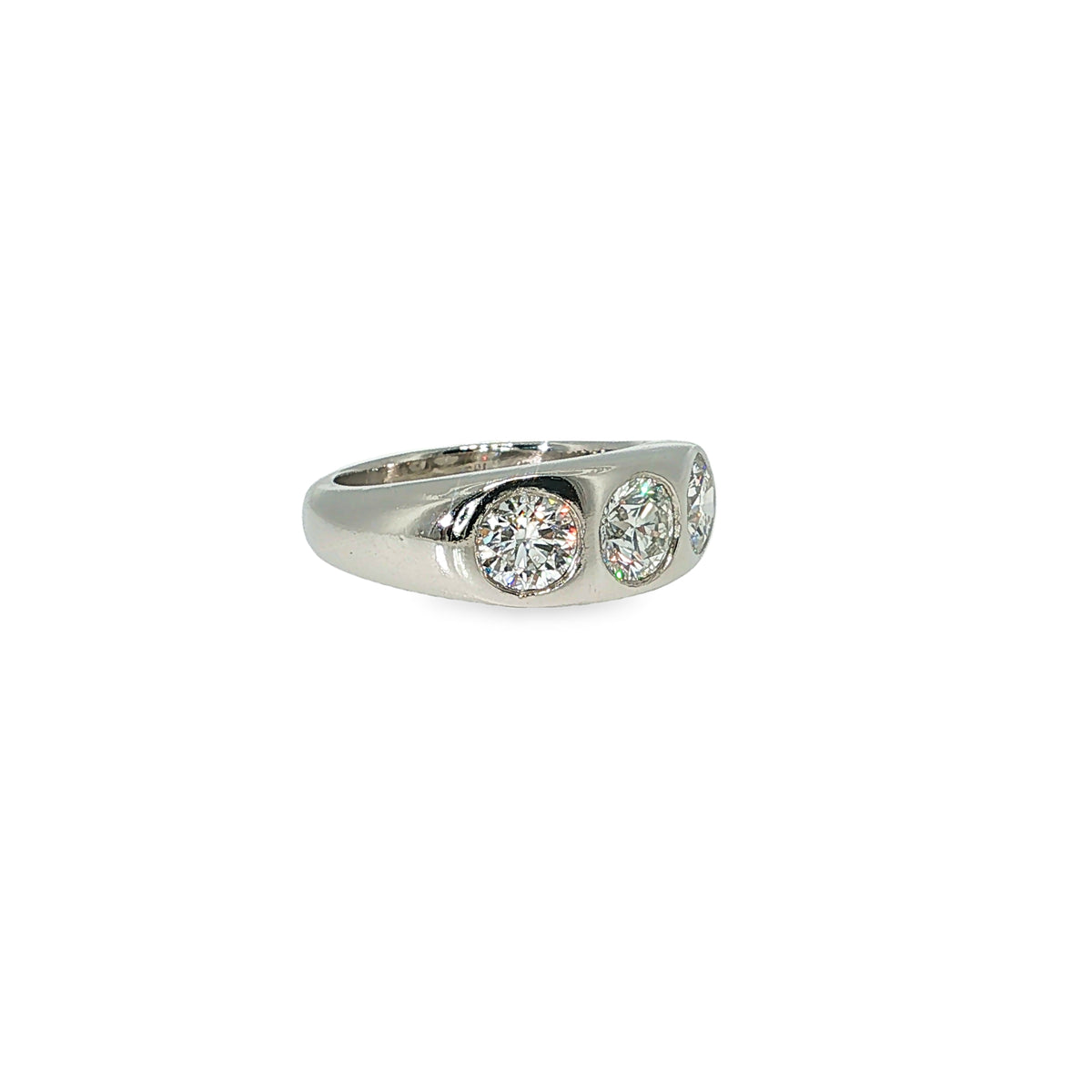 Platinum band with three round brilliant diamonds flush set across the center.