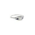 18K white gold vintage-style ring with an Old European cut diamond center and deep blue synthetic sapphire accents.