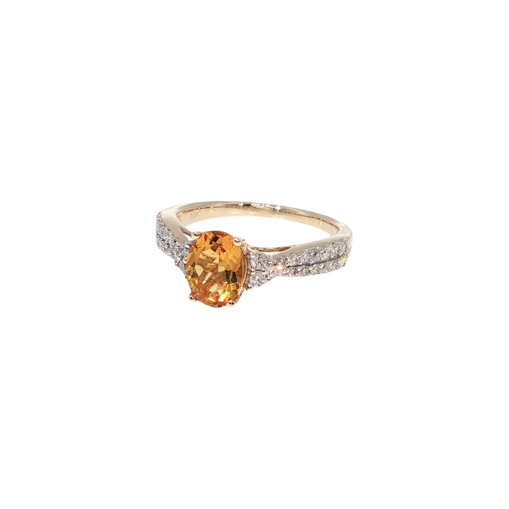 10K yellow gold ring with an oval golden citrine surrounded by a halo of round brilliant diamonds.