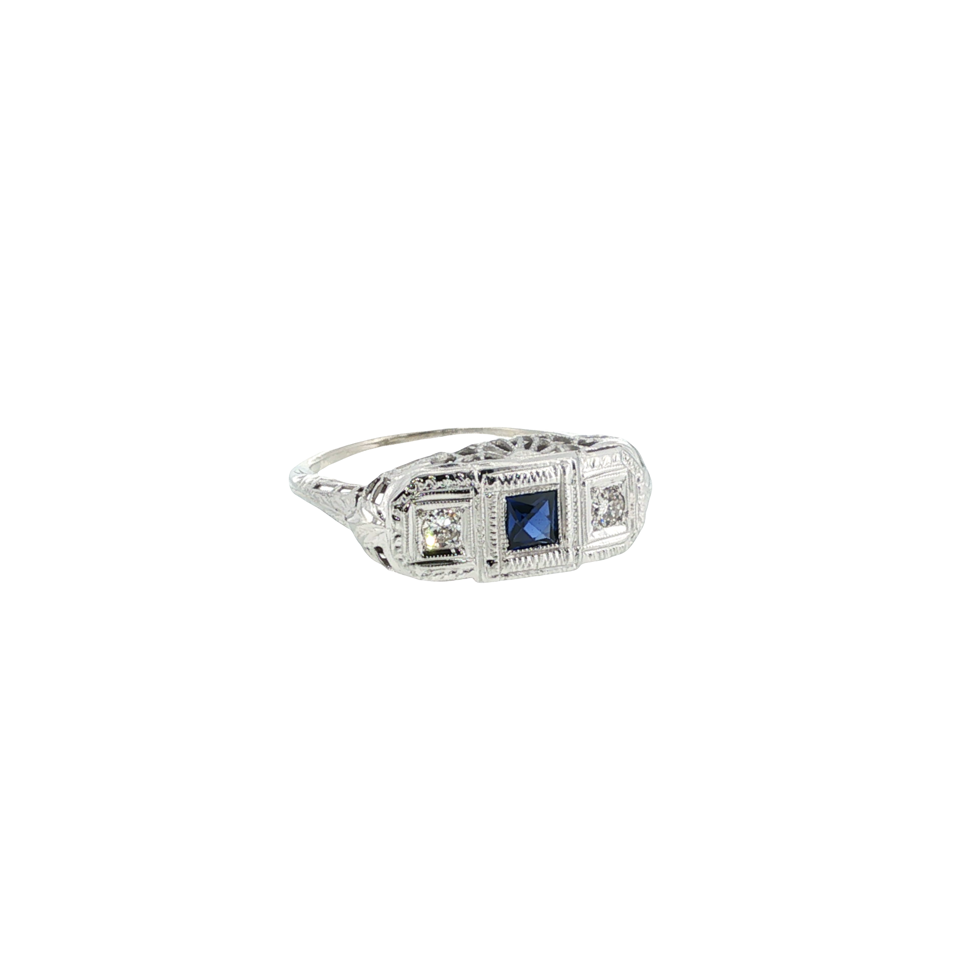 14K white gold filigree ring with a princess-cut blue synthetic sapphire and two round diamond accents.