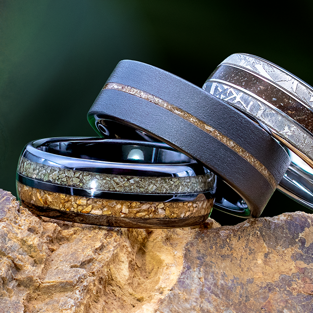 Three men’s bands featuring dark metals and natural inlays