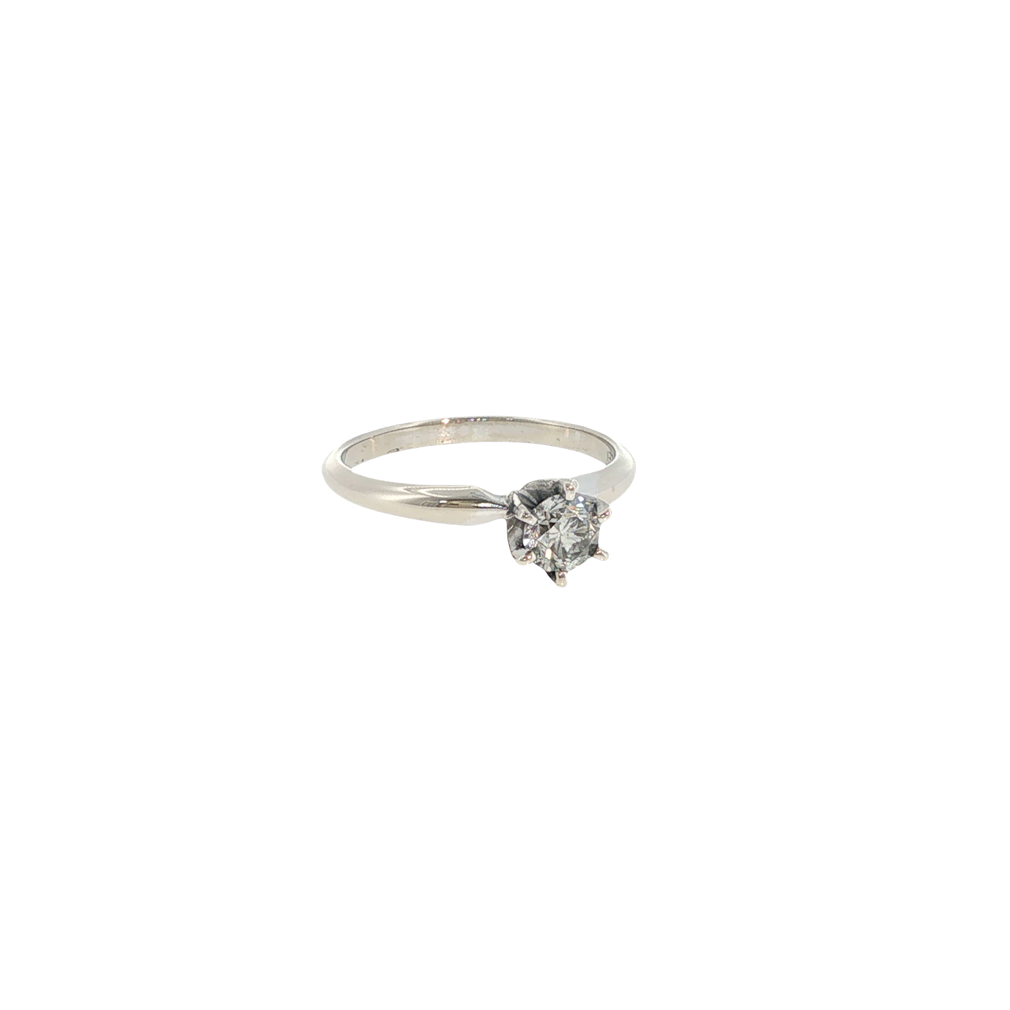 14K white gold solitaire ring with a round diamond held in a classic six-prong setting.