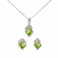 14K white gold matching pendant and earring set with vivid green peridot gemstones in angular geometric frames accented with diamonds.