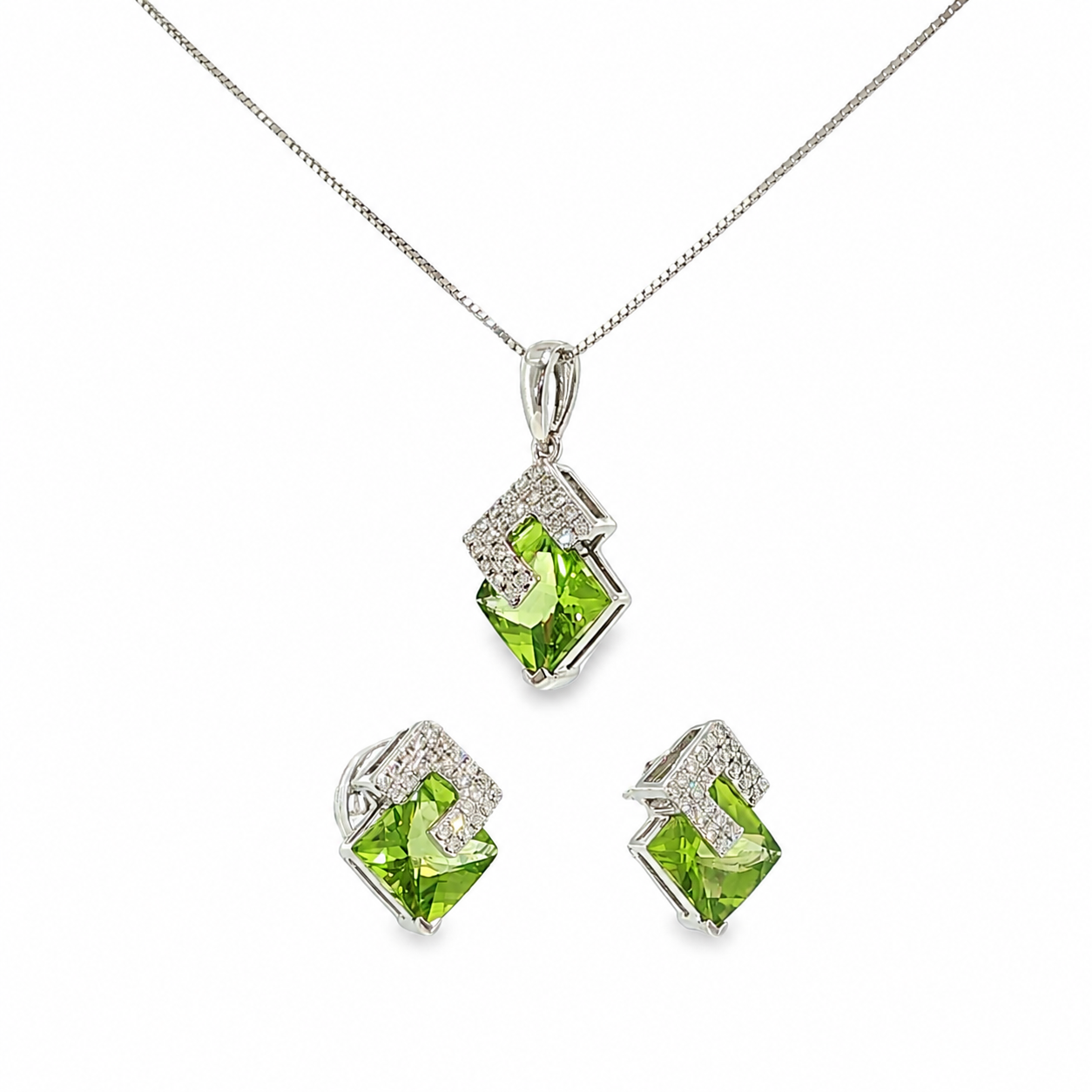 14K white gold matching pendant and earring set with vivid green peridot gemstones in angular geometric frames accented with diamonds.