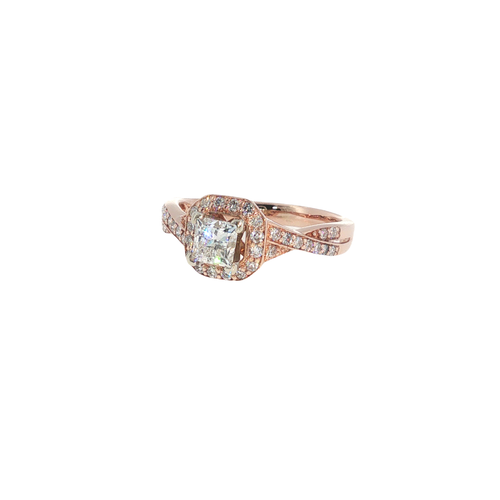 14K rose gold halo ring with a cushion-cut center diamond surrounded by round diamond accents.