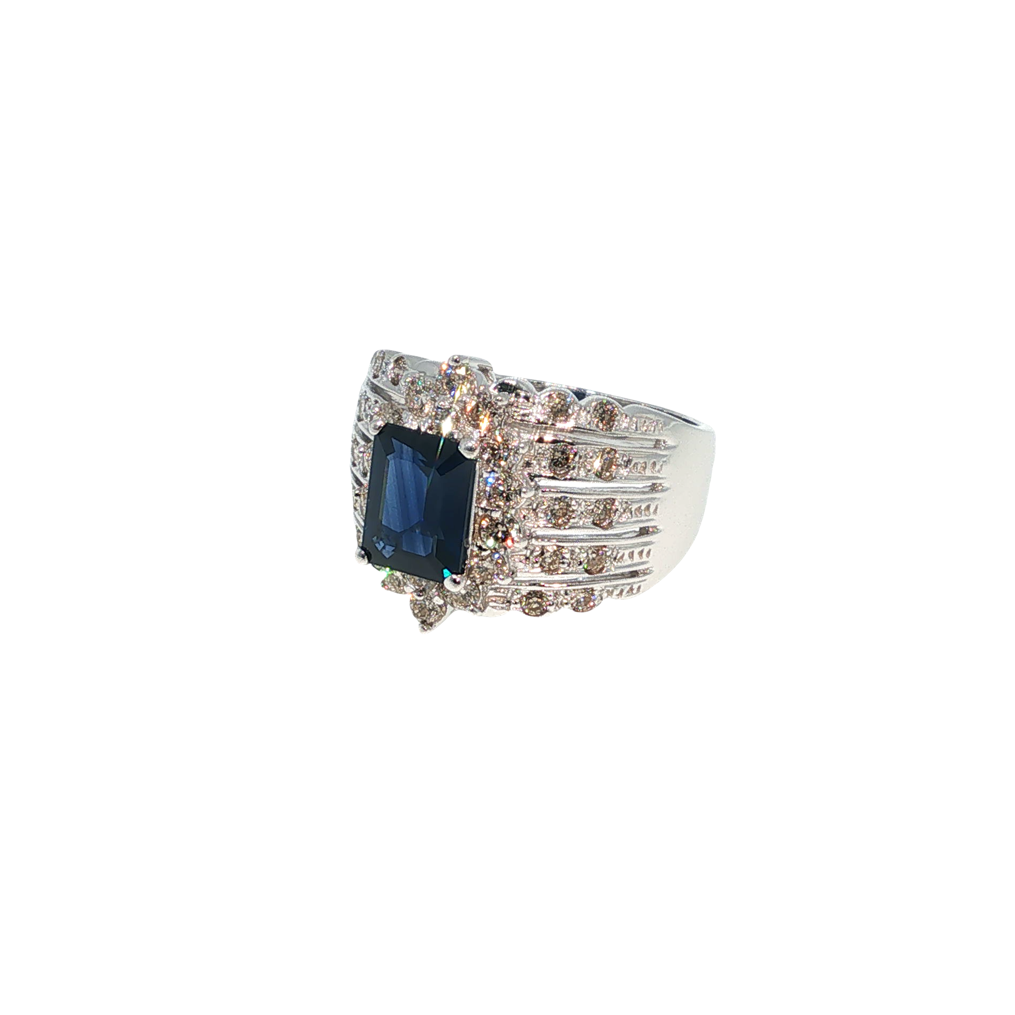 14K white gold ring with an emerald-cut blue sapphire surrounded by a halo of light brown diamonds.