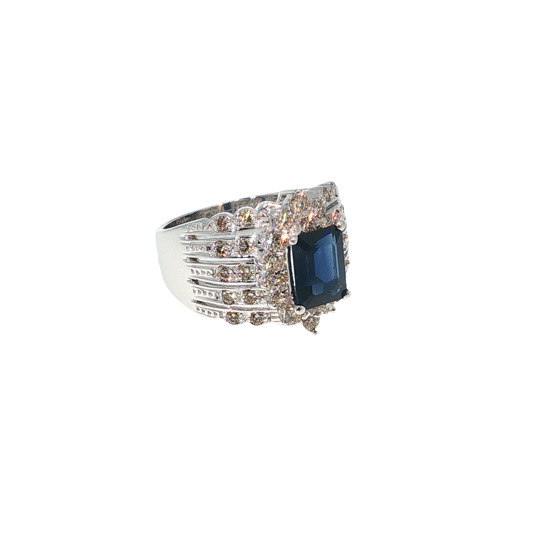 14K white gold ring with an emerald-cut blue sapphire surrounded by a halo of light brown diamonds.