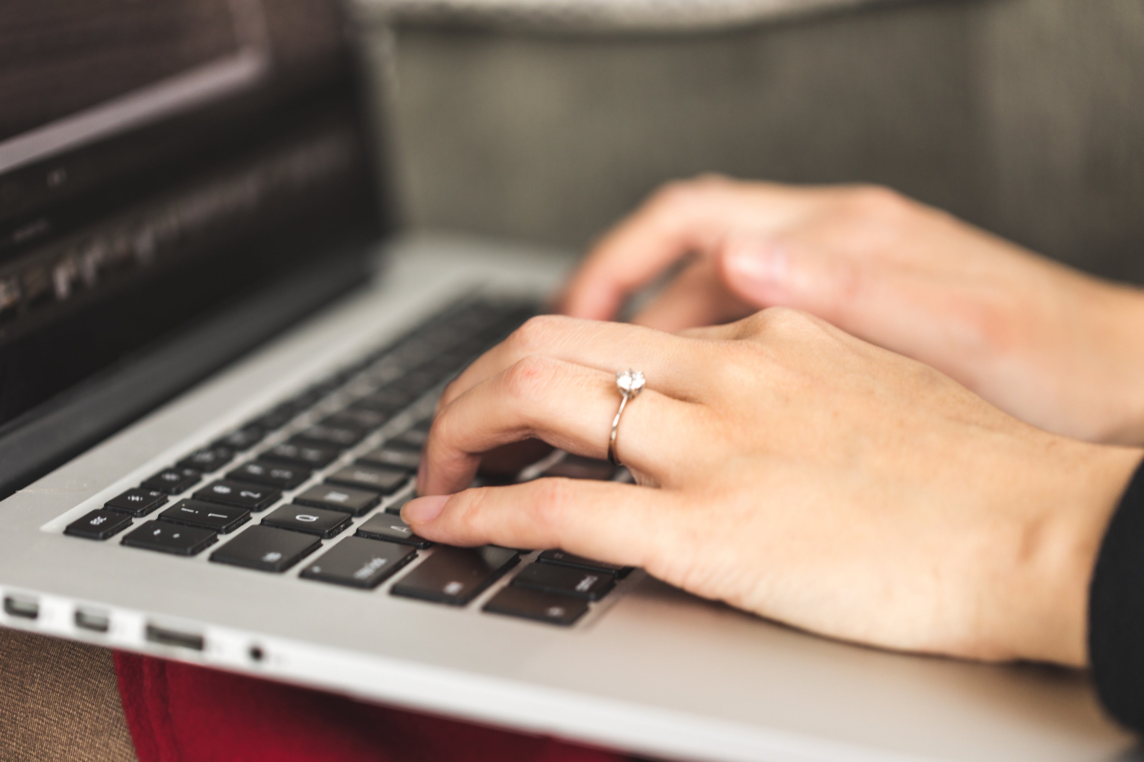 Hands typing on a computer keyboard