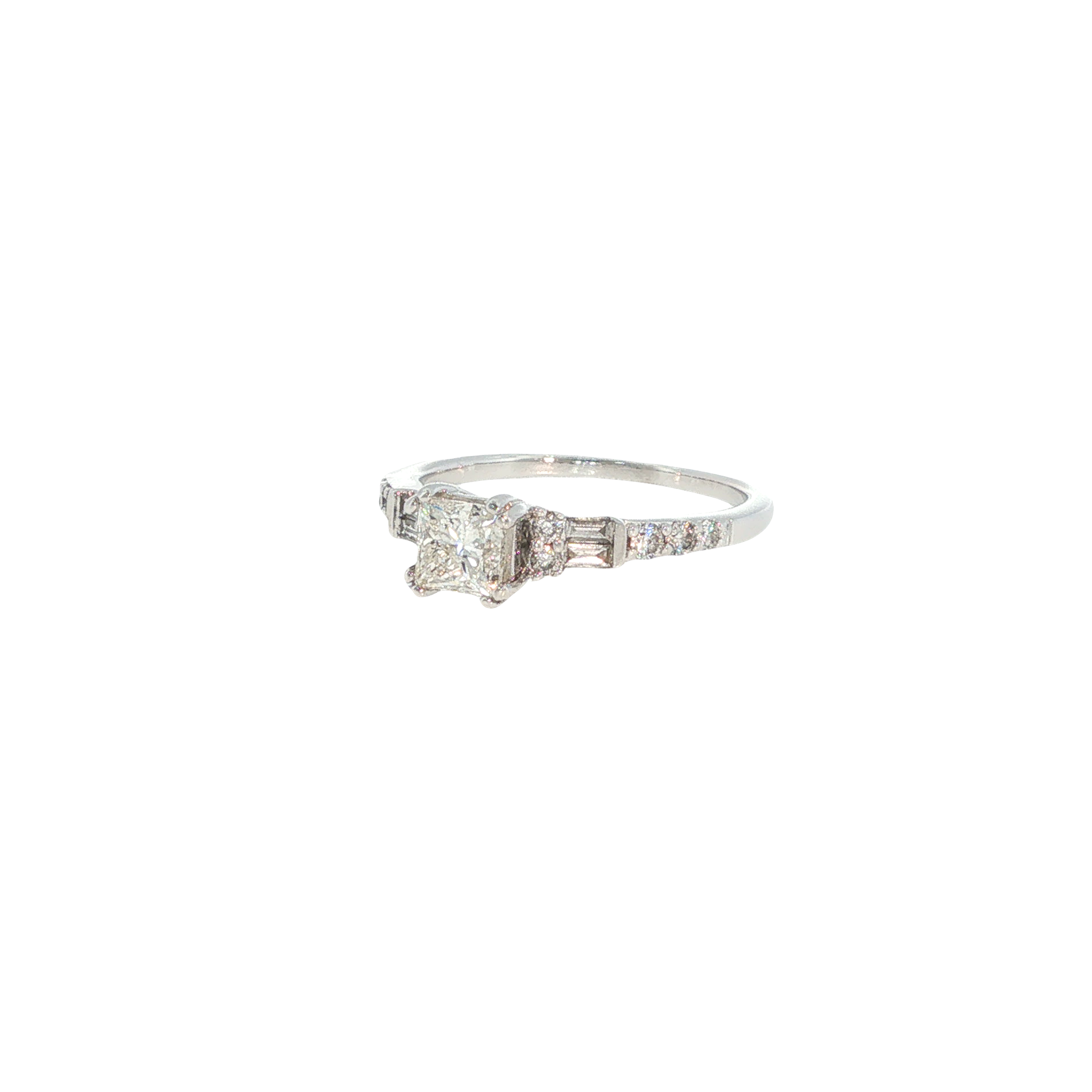 14K white gold ring with a round center diamond and tapered baguette and round diamond accents.