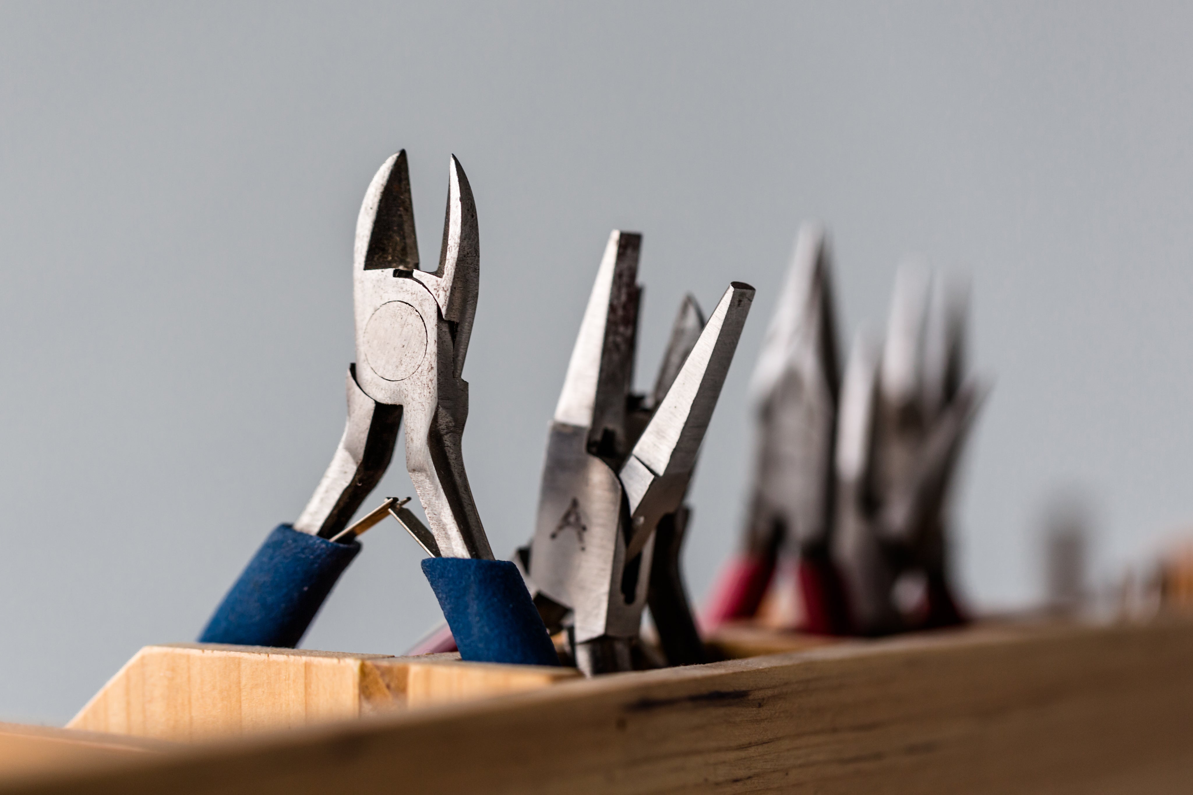 Jeweler working with handheld tools at a workbench