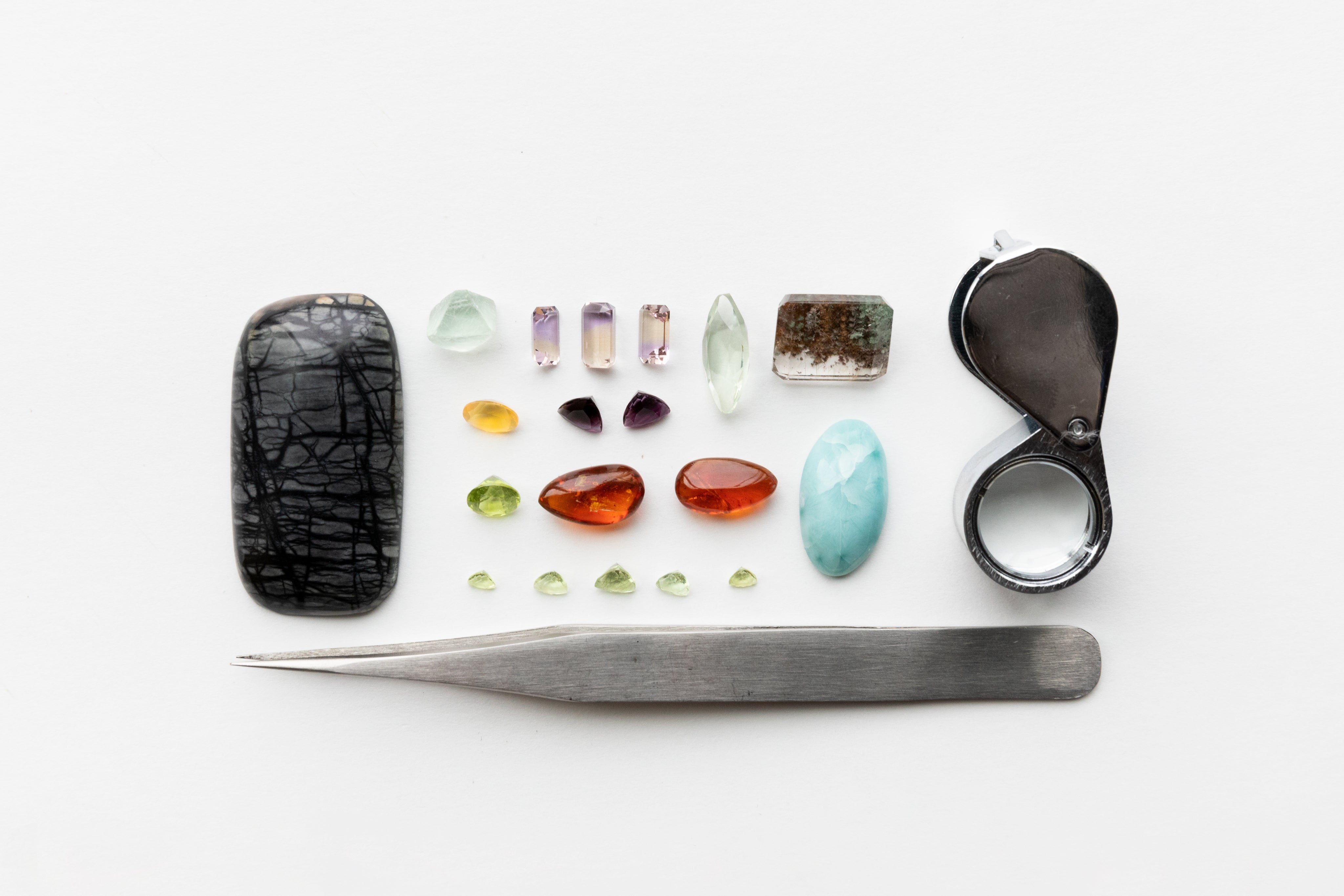Jewelry components and loose gemstones arranged for study