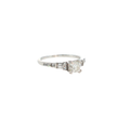 14K white gold ring with a round center diamond and tapered baguette and round diamond accents.