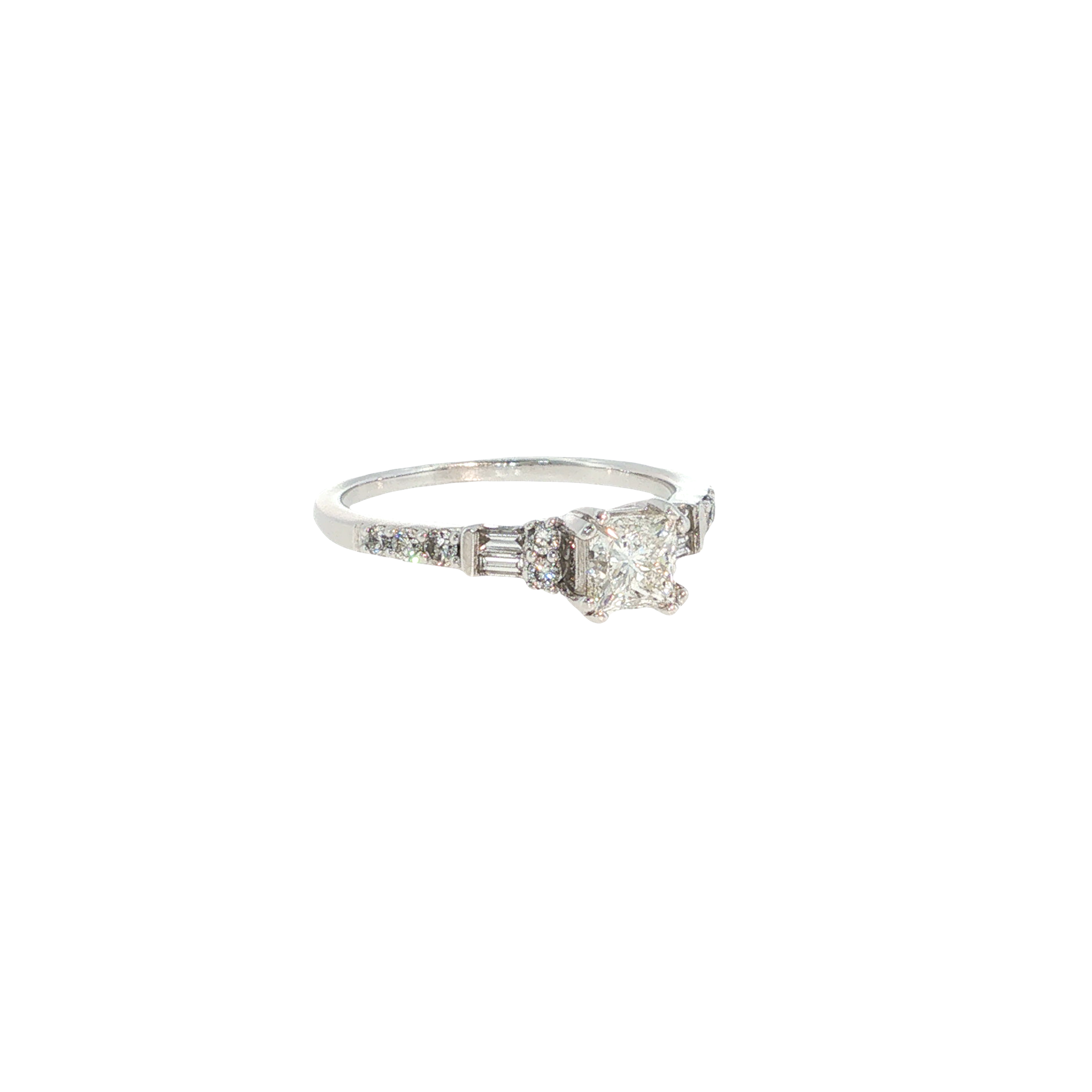 14K white gold ring with a round center diamond and tapered baguette and round diamond accents.