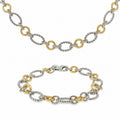 Sterling silver and 18K yellow gold matching necklace and bracelet set with alternating twisted silver links and polished yellow gold circular links.