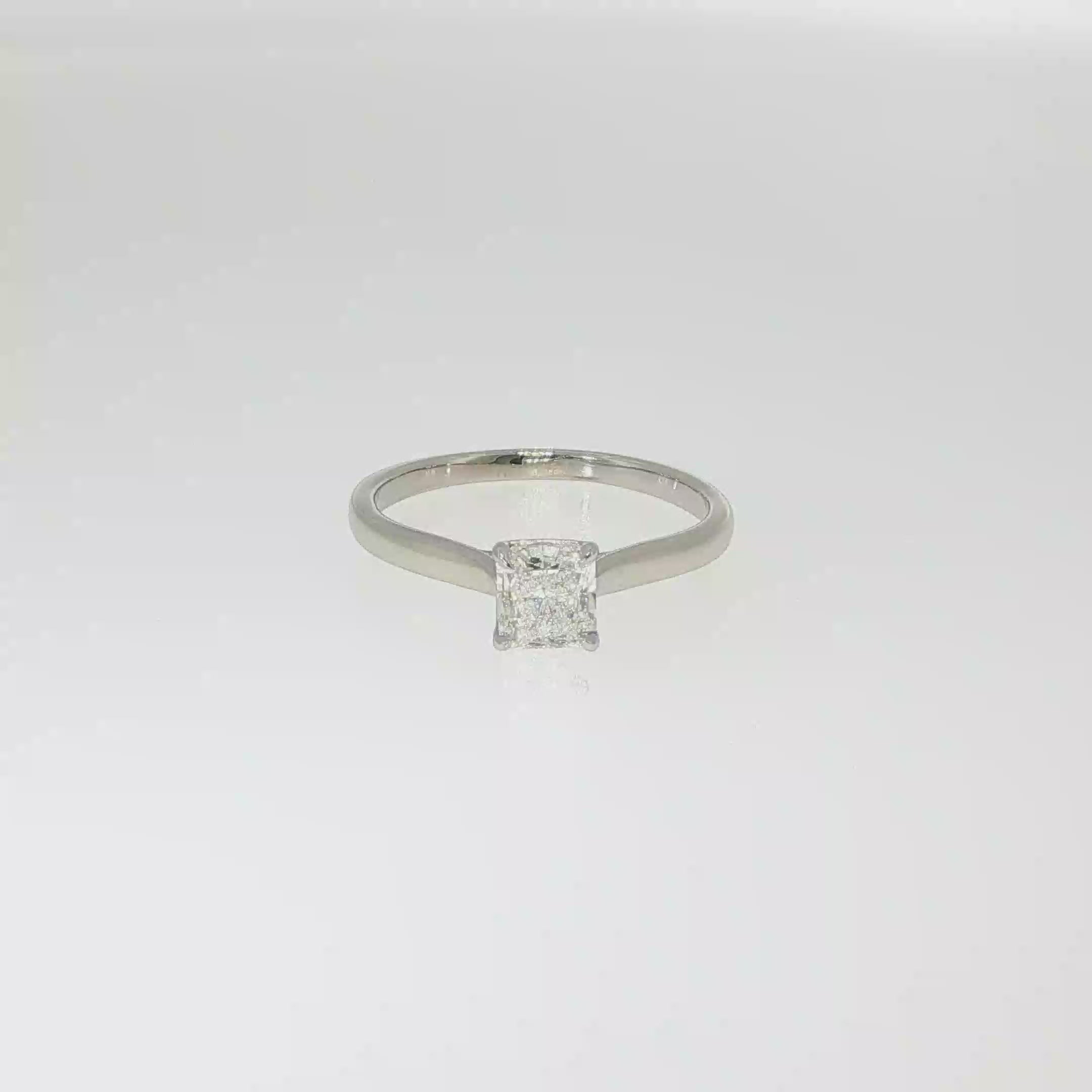 Natural radiant-cut diamond solitaire engagement ring in 14K white gold with a four-prong setting.