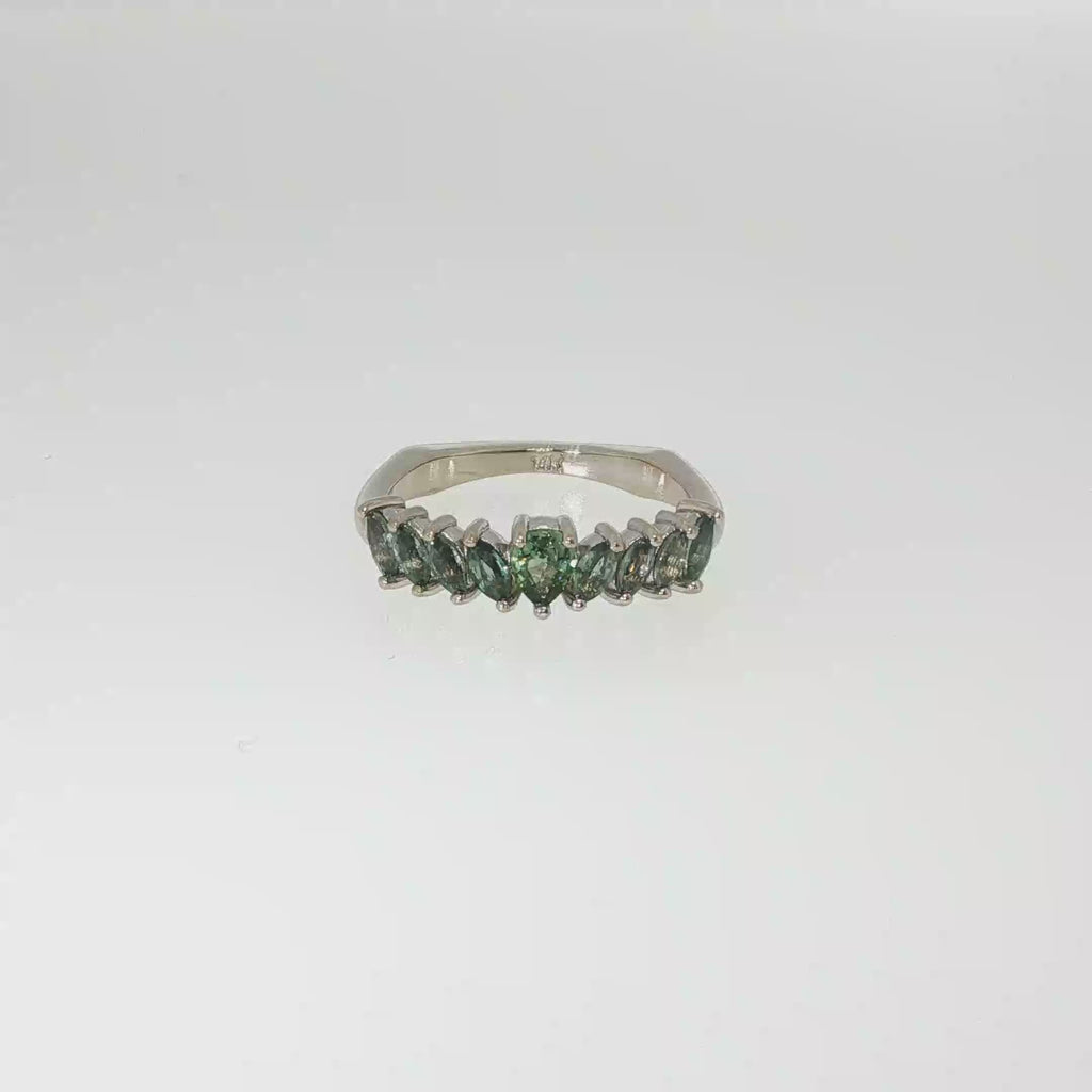 14K white gold graduated band set with nine green Montana sapphires in mixed shapes.