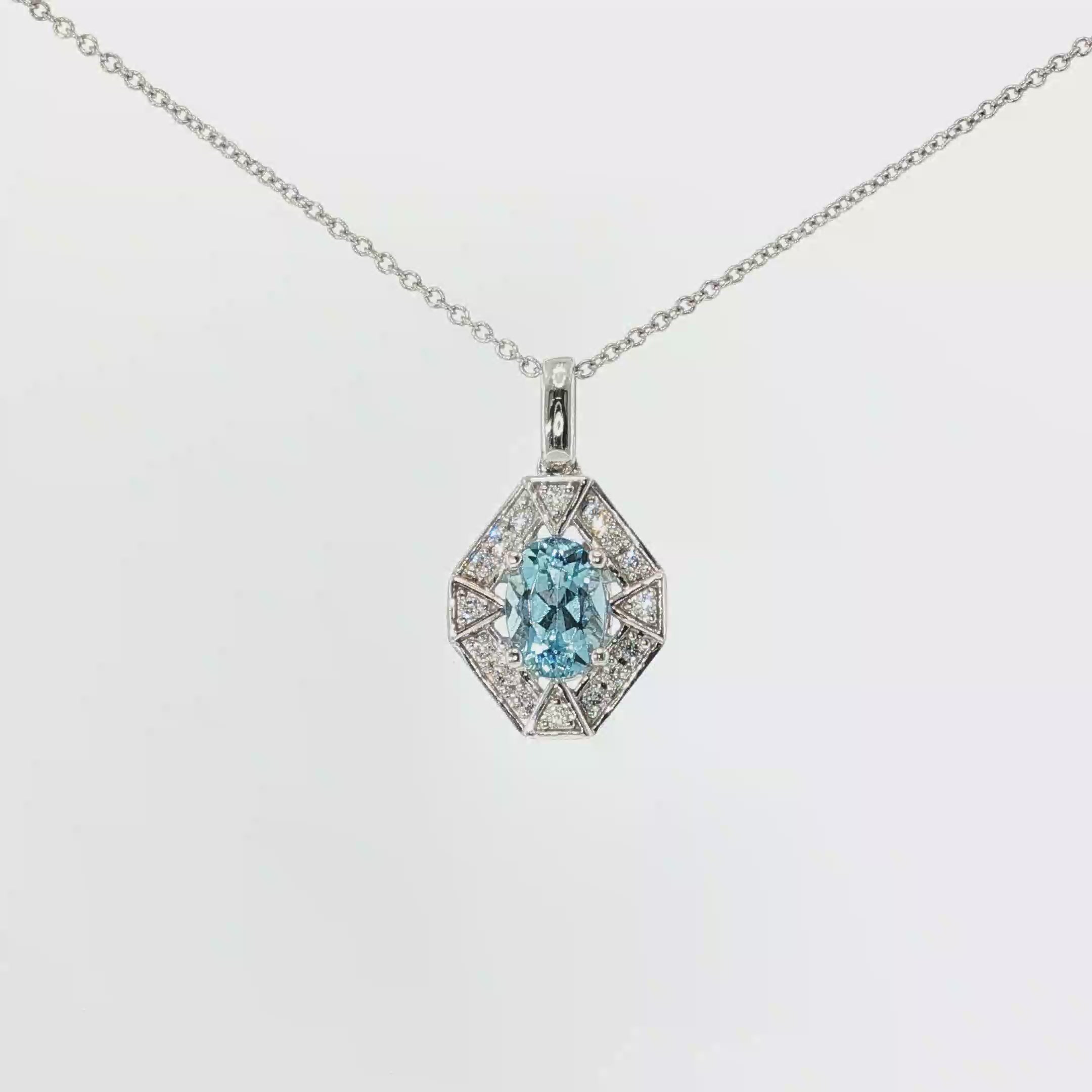 Oval aquamarine and diamond geometric pendant necklace in 14K white gold.