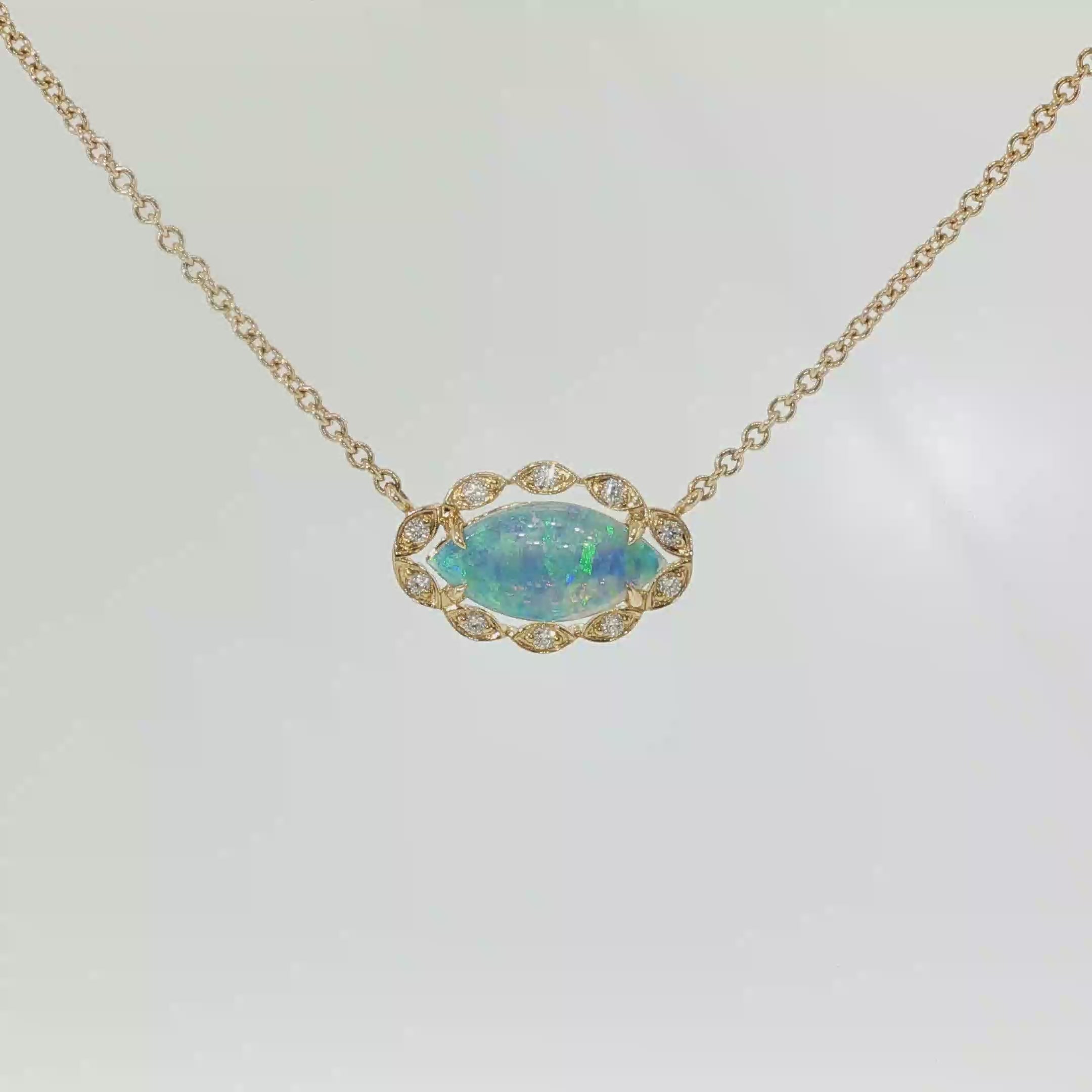 14K yellow gold necklace with a marquise Australian opal framed by diamond accents on an 18-inch chain.