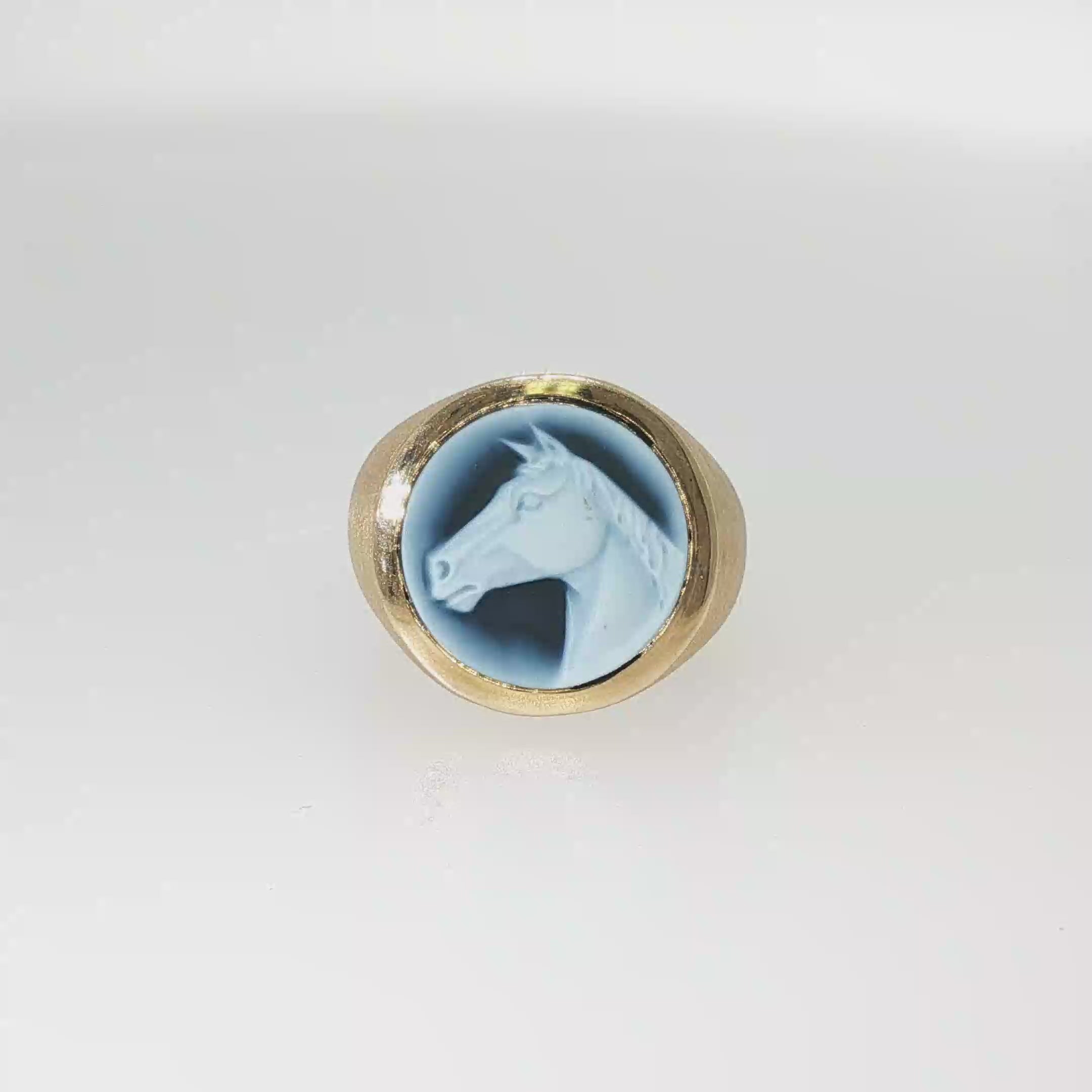 14K yellow gold ring with a round blue and white carved Wedgwood horsehead cameo.