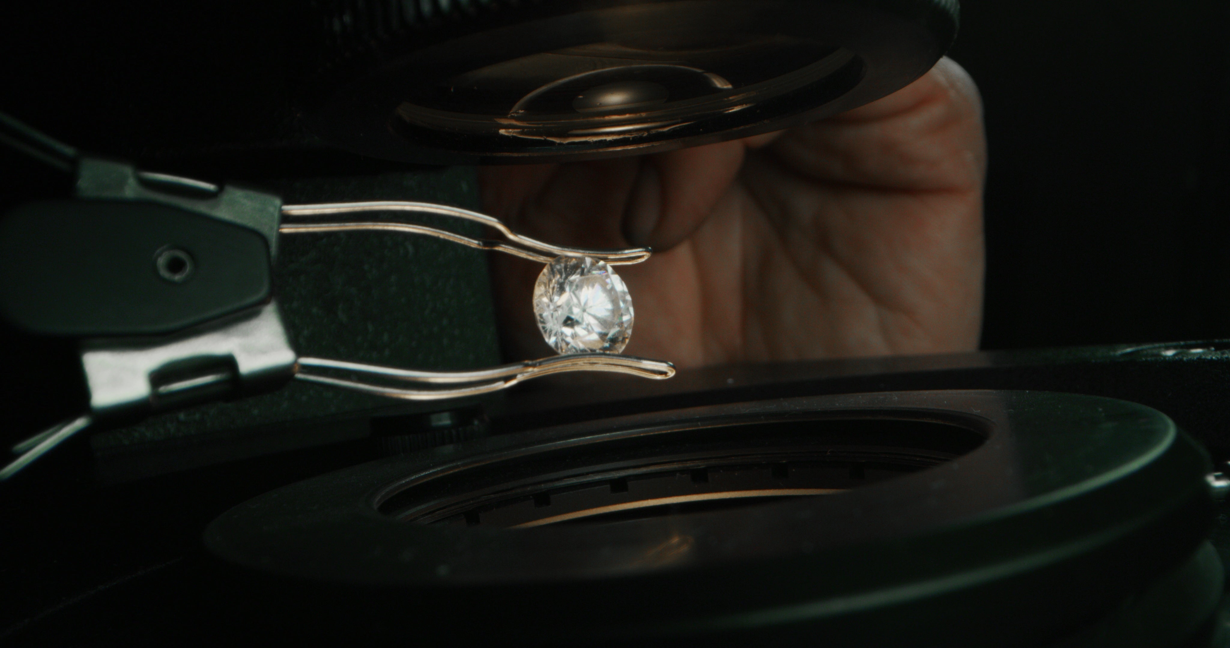 Jeweler carefully inspecting a diamond